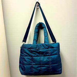 Isaac Mizrahi navy blue, quilted travel bag with silver hardware.